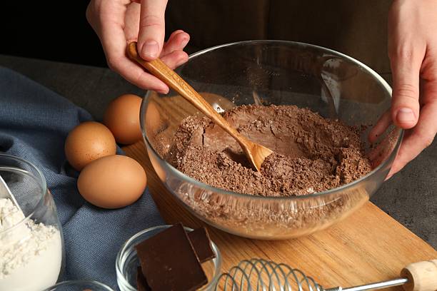 istock Woman making chocolate dough at grey table, closeup 2212678768