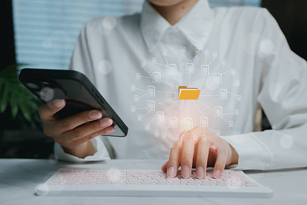 istock Person Using Smartphone and Computer to Manage Digital Files, business concept 2212681145