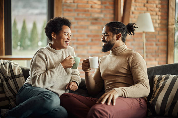 istock Happy black couple talking during tea time at home. 2212681399