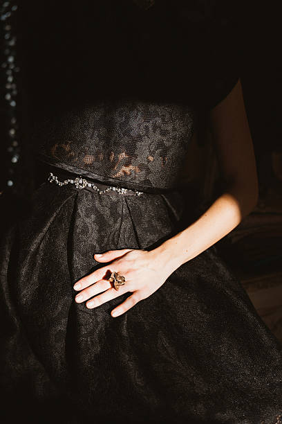 istock Elegant Black Dress with Ring in Dramatic Lighting 2212681449
