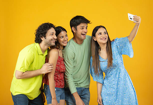 istock Friends taking selfie with mobile phone on white background 2212681555