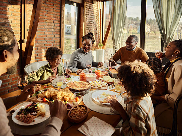 istock Happy black multi-generation family having a meal at dining table. 2212682066