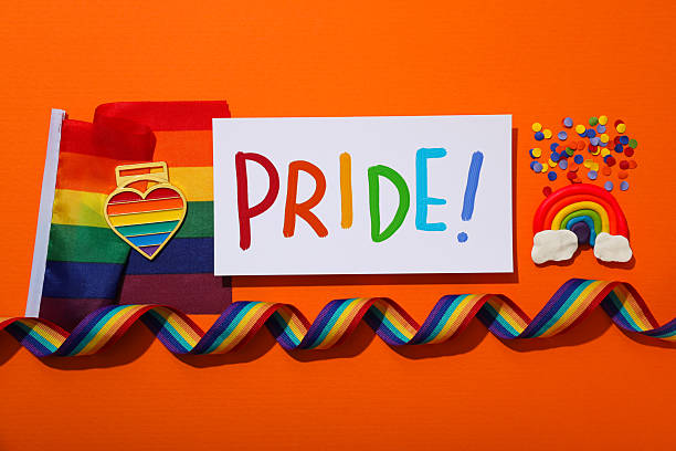 istock LGBT parade concept, symbols on orange background. 2212682281