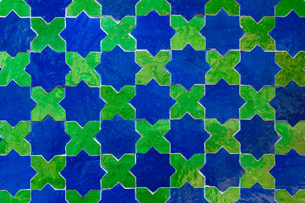 Zellige tilework from Marrakesh in vivid blue and green displays traditional Islamic artistry with geometric patterns, reflecting ancient craftsmanship, cultural richness and architectural heritage.