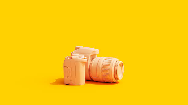 istock Camera Yellow Background Vivid Peach Tones 2212684173