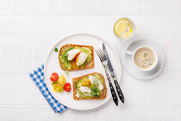 istock Delicious avocado toasts topped with perfectly cooked poached eggs 2212688111