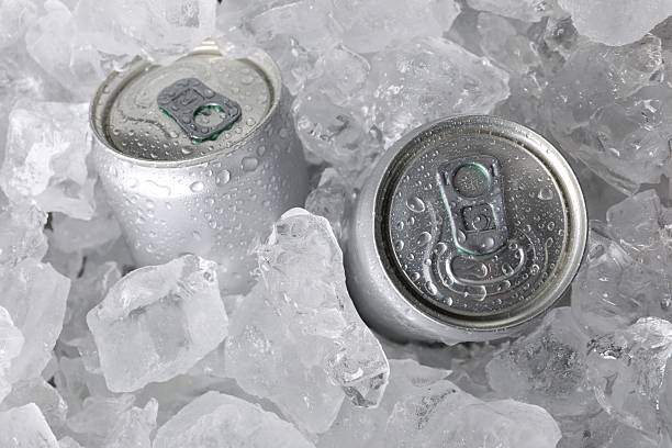 istock Cans of refreshing drink in ice cubes, above view 2212688295