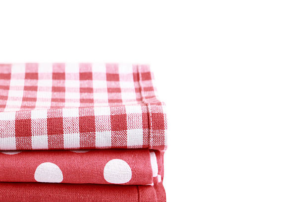 istock Stack of red polka dot and checkered kitchen towels isolated on white background 2212691525