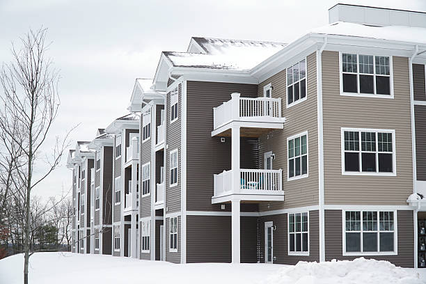 istock modern apartment building after winter snow storm 2212691546