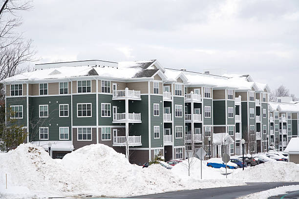istock modern apartment building after winter snow storm 2212691629