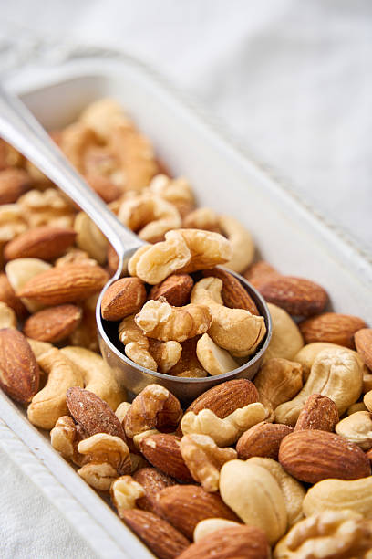 Healthy Mixed Nuts in a White Plate with Spoon