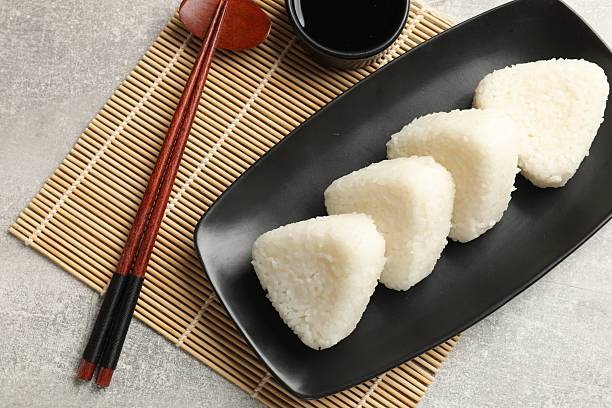 istock Tasty onigiri (Japanese rice balls) served on grey table, flat lay 2212692500