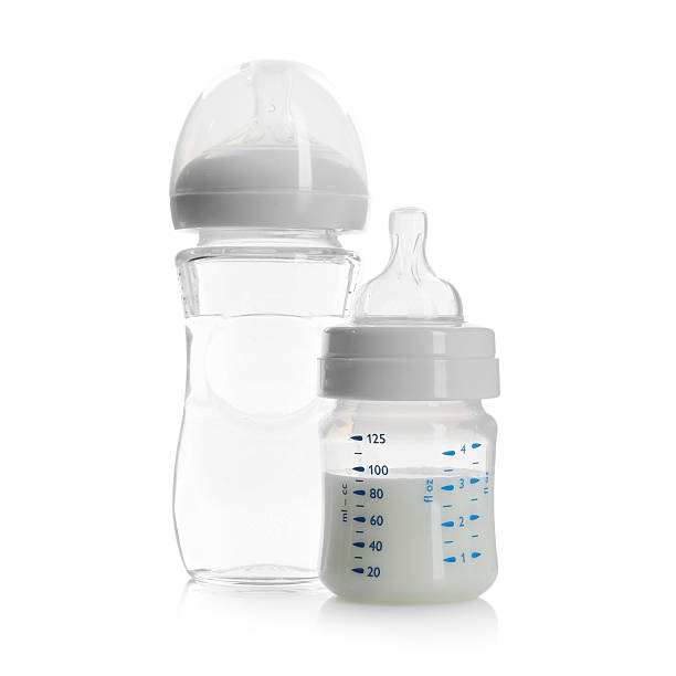 istock Feeding bottles with milk and water isolated on white 2212692643