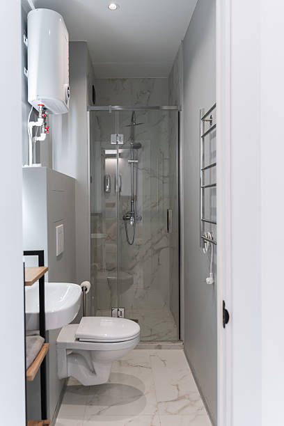 istock bathroom with grey tiles, white sink, white toilet. 2212693855
