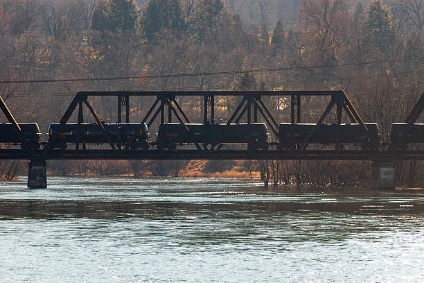 Kamloops, Canada - April 26, 2025: Looking east to the South Thompson River. The Kamloops CN Railway Bridge is a swing bridge that connects downtown and the Kamloops Indian Reserve No. 1 to the north. Spring morning in the Thompson-Nicola Regional District.