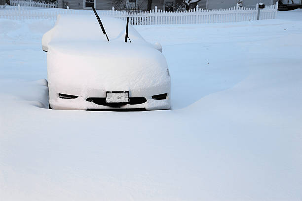 istock car covered by snow in blizzard 2212695997