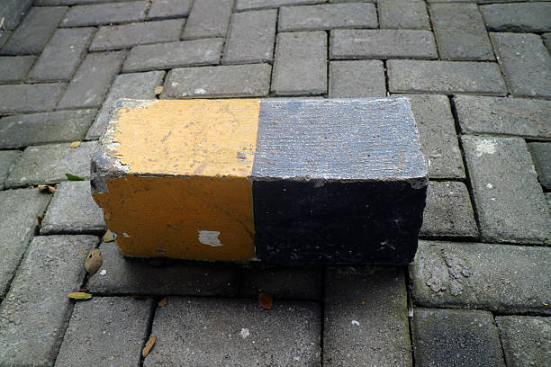 Yellow and black concrete block on paved street
