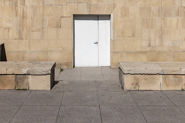 A gray building with a white gate