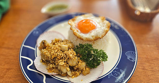 istock Stir-fried Scallops with garlic with streamed rice serving on blue plate 2212697447