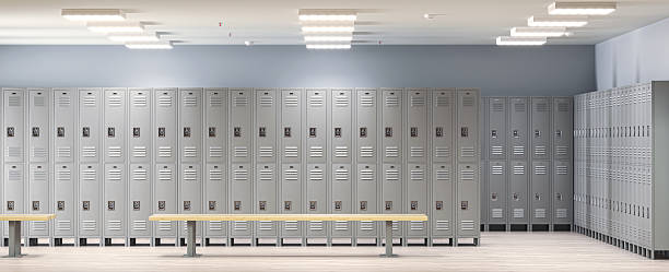 istock Empty school locker room with gray lockers and benches 2212699633