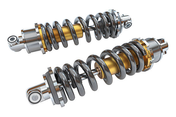 istock Two metal shock absorbers with gold springs on white background 2212700036