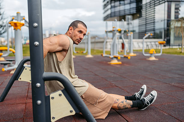 istock Young Man Doing Dips On A Bar In An Outdoor Gym 2212700623