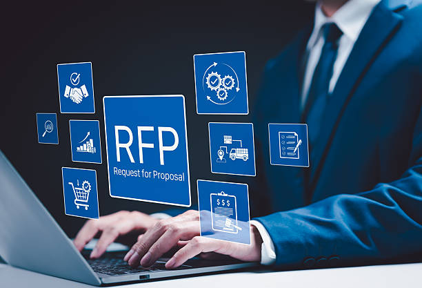 istock RFP, Request for Proposal Business Concept. Businessman working on laptop with icon representing Request for Proposal (RFP) process, including procurement, bidding, contract management, and logistics. 2212701114