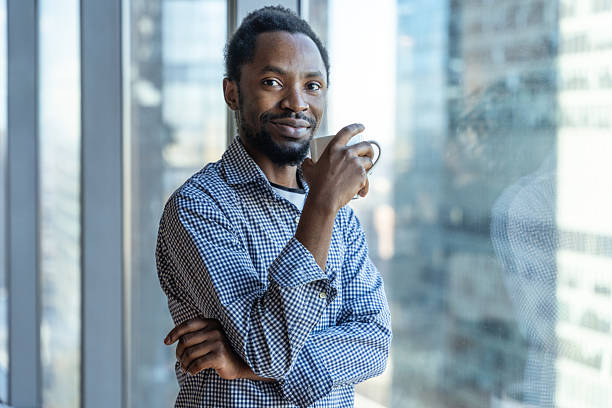 istock Confident Businessman Enjoying Coffee By A Window With A Cityscape Background 2212701368