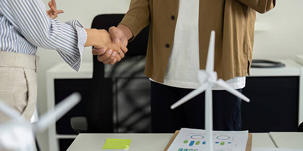 istock Sustainability teamwork: Professionals shaking hands on eco-friendly goals 2212701502