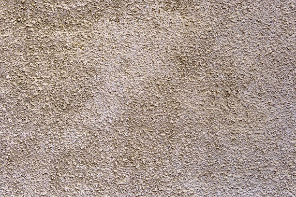 istock A wall with a textured surface. The wall is tan in color. 2212702643