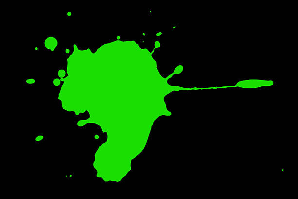 Green blot on a black background. Spots of paint on a piece of paper.