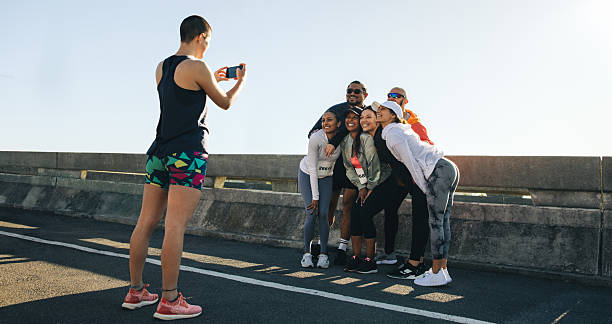 istock Group of cheerful runners posing for a photo during a marathon 2212702978