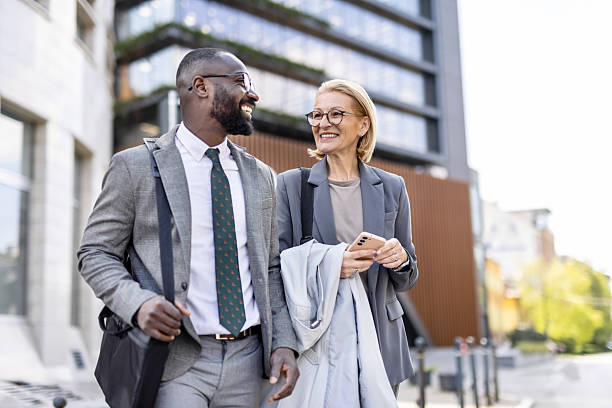 istock Friendly business conversation between colleagues outside 2212704335