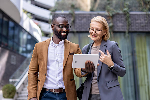 istock Two Colleagues Reviewing Work on a Tablet Outside Together 2212704345