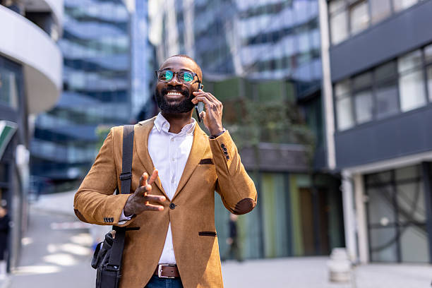 istock Confident professional answering phone outdoors with enthusiasm 2212704346