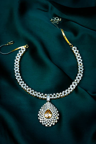 istock Luxurious White Stone Necklace on Elegant Green Silky Background 2212704975