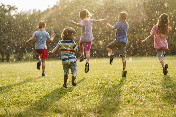 istock Children run in the rain on a sunny day 2212705818