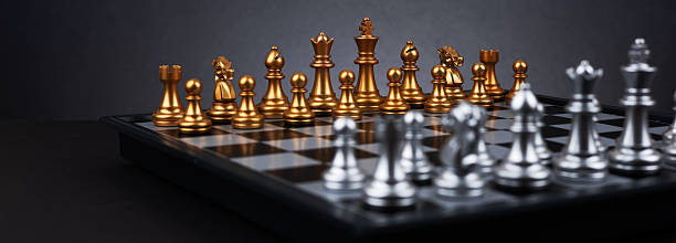 istock chessboard with chess pieces ready for the game on dark background 2212705961