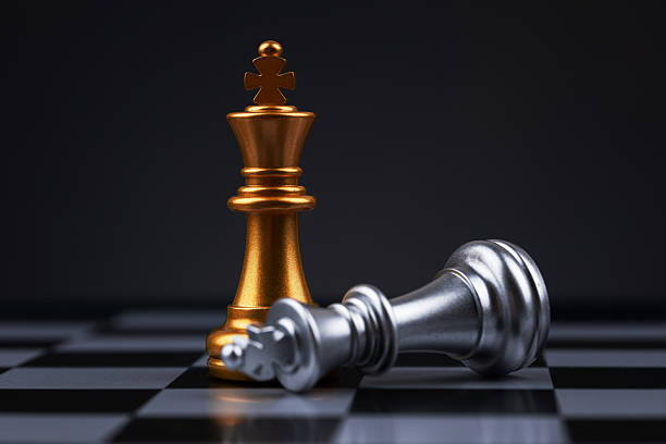 istock chess pieces The golden king stood beside the fallen silver king 2212705990