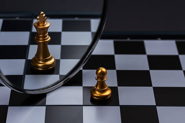 istock Chess pawn looking its reflection on a mirror and seeing itself as a King, Think Big 2212706016