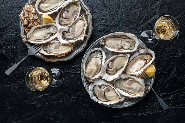 istock Fresh raw oysters on ice, overhead flat lay shot 2212706073