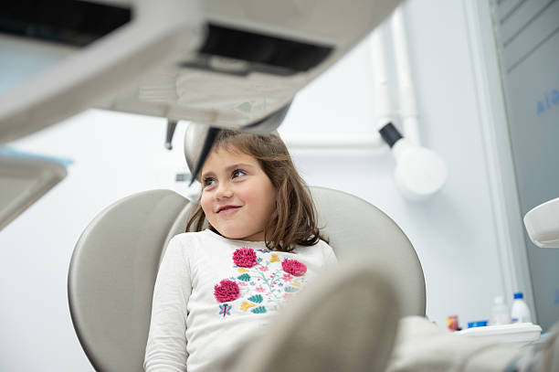 istock Smiling girl having dental check-up at dentist's office 2212706612