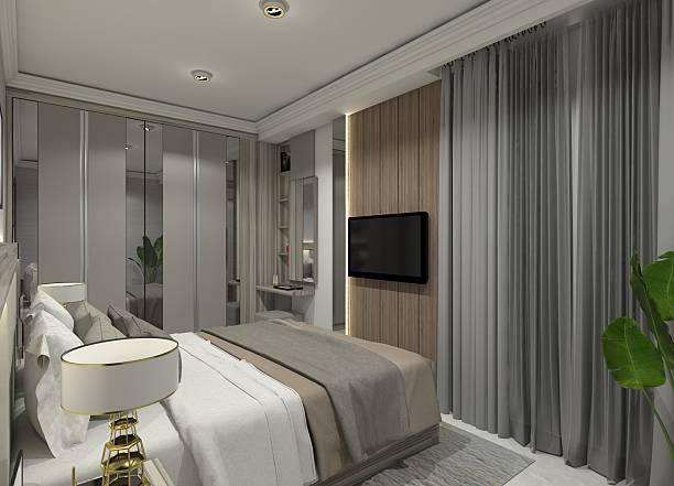 istock Contemporary 3D rendering of a minimalist bedroom interior featuring a bed with a headboard, closet, vanity table, and floating TV panel. 2212708500