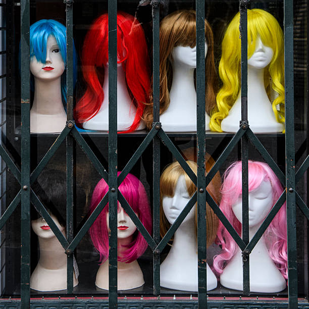 istock Styrofoam mannequin heads with multi-colored women's wigs in a window display. 2212711104