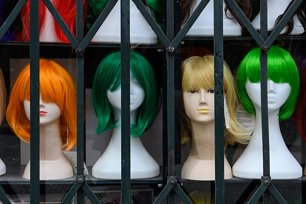 istock Styrofoam mannequin heads with multi-colored women's wigs in a window display. 2212711117