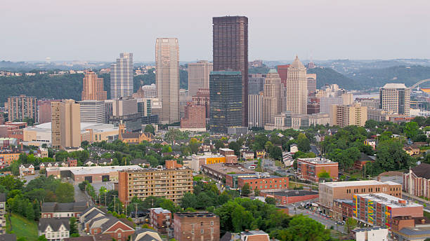 istock Downtown Pittsburgh Skyline with Lush Greenery and Sunset Hues 2212713173