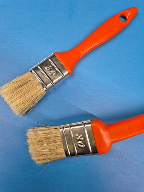 istock two paint brushes with orange plastic handles and light bristles. size 30 2212715631