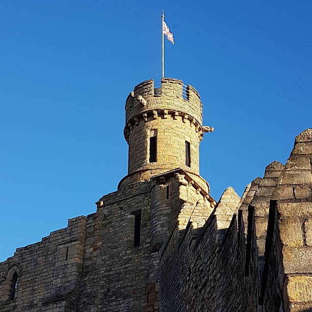Cardiff, Wales - November 13, 2025: Medieval stone walls and defensive towers of Cardiff Castle in Cardiff, Wales, UK. The fortifications reflect the site’s long history from the Norman period onward within the modern city.
