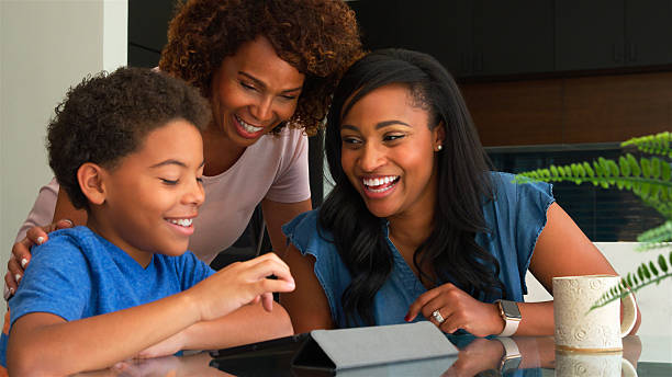 istock African American Parents Helping Son Studying Homework Around Table In Kitchen 2212715842