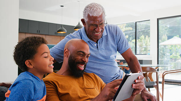 istock African American Family With Son Sitting On Sofa At Home Using Digital Tablet 2212715844
